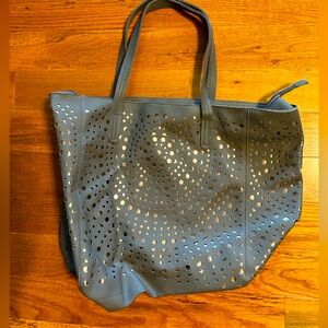 This tote purse has the gray design overlay over a bronze colored background.